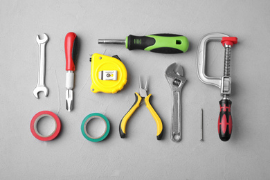 Photo of Flat lay composition with construction tools on light grey background