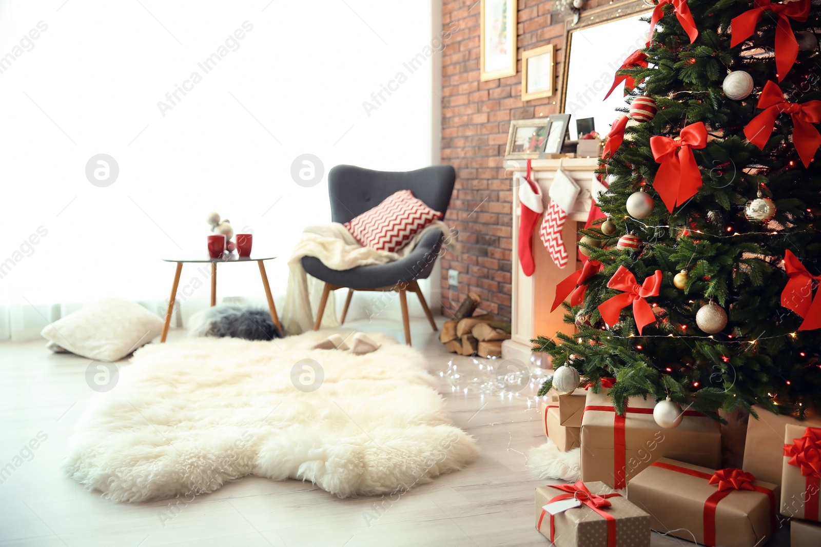 Photo of Room interior with beautiful Christmas tree and gifts near decorative fireplace