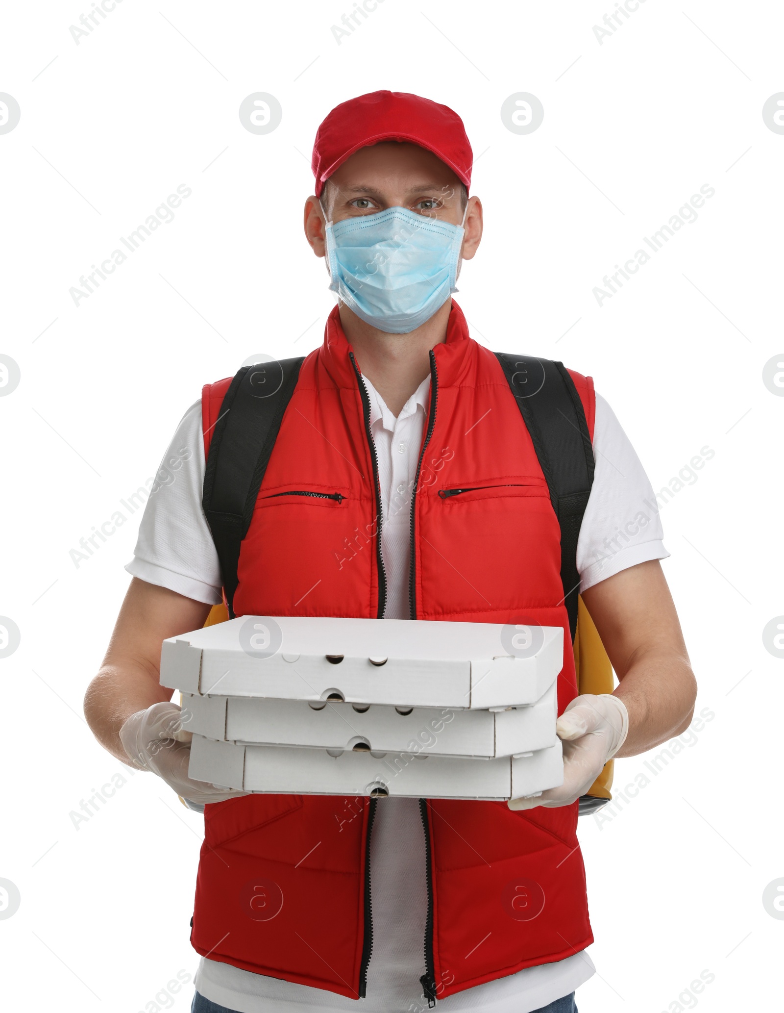 Photo of Courier in protective mask and gloves holding pizza boxes on white background. Food delivery service during coronavirus quarantine