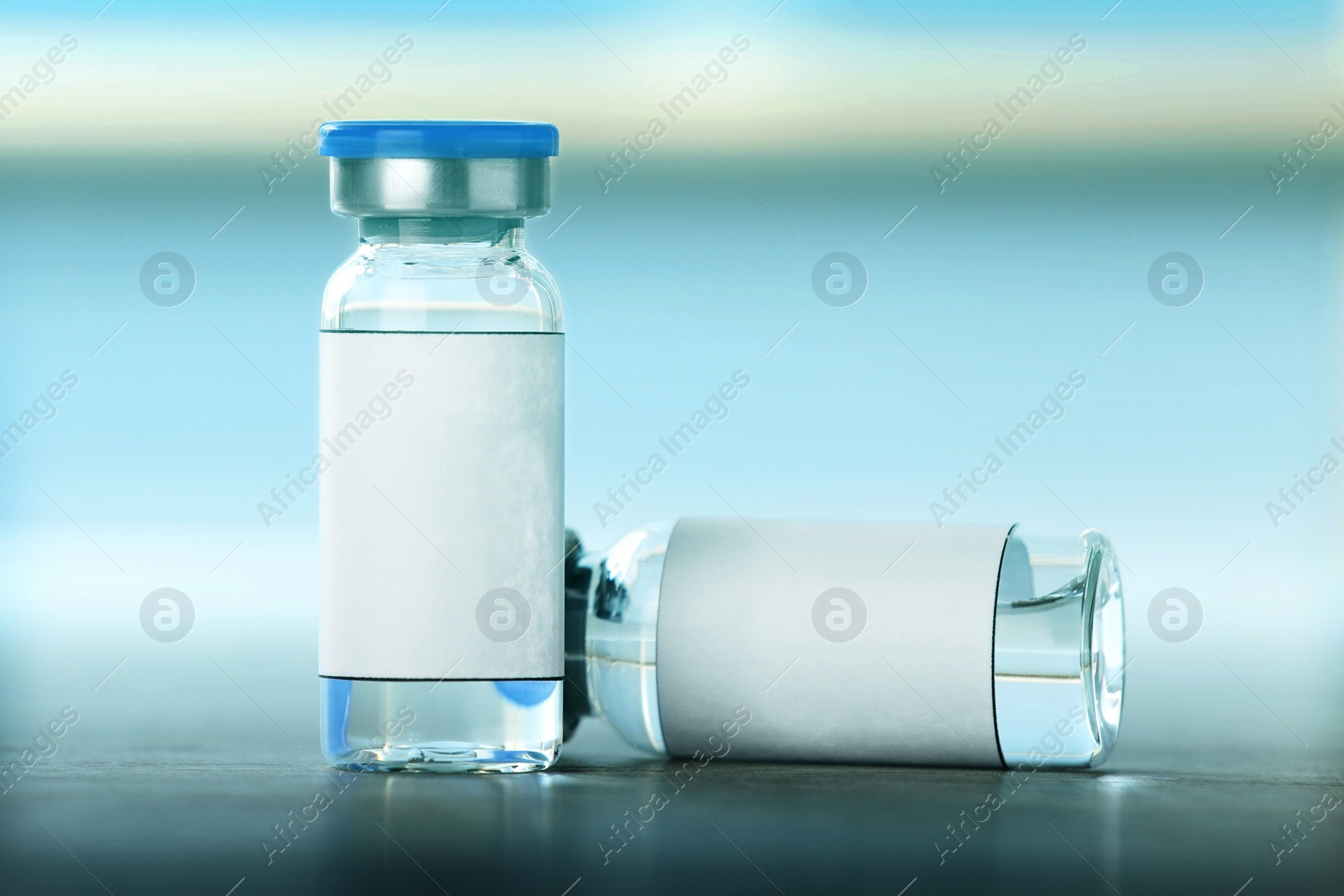 Image of Medication in vials on table, space for text