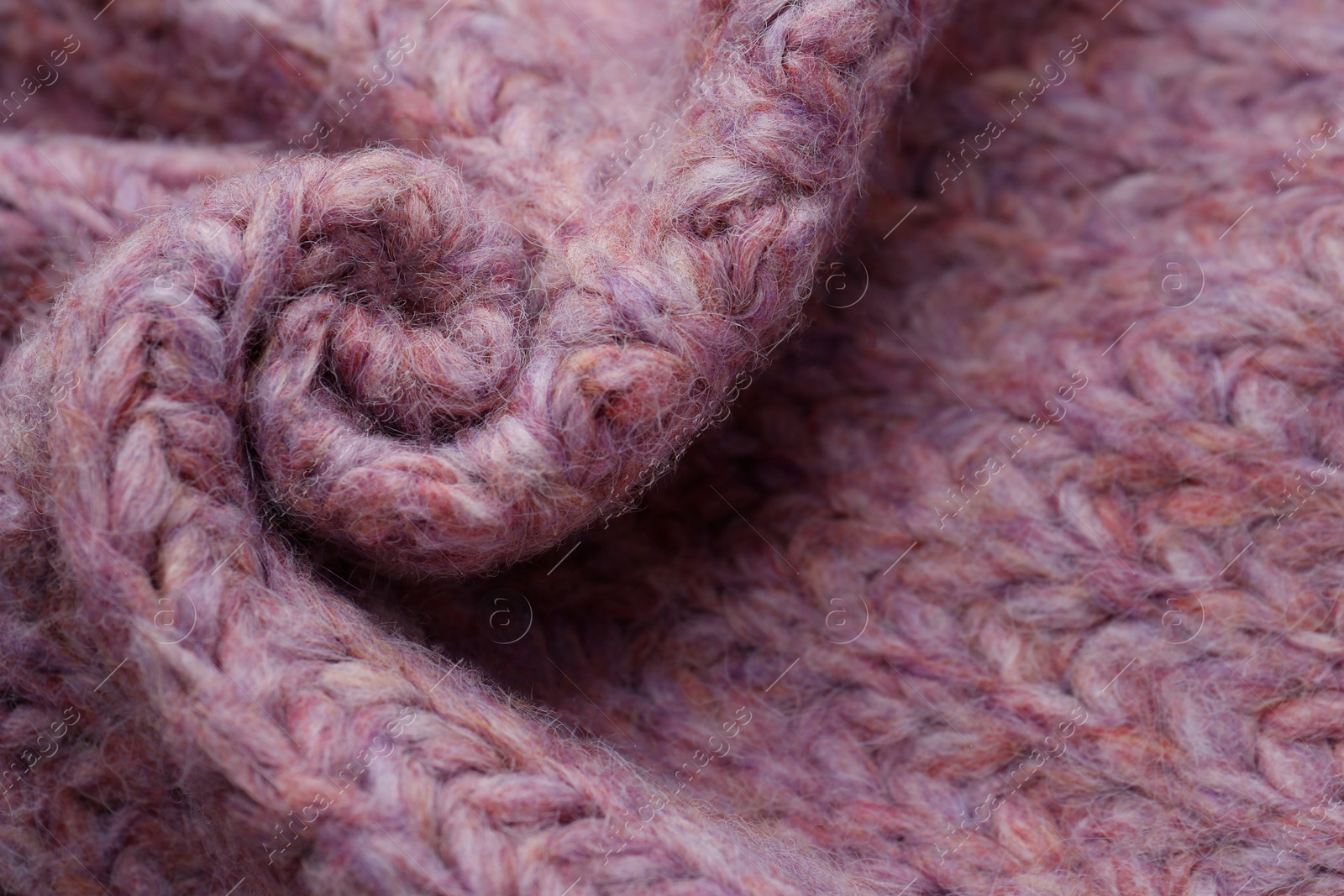 Photo of Closeup of violet knitted fabric as background, above view