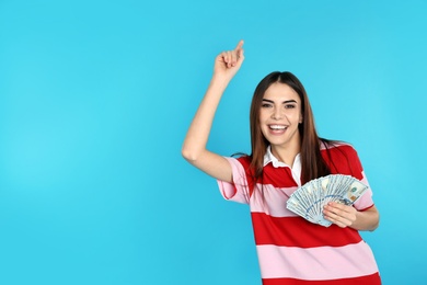 Young woman with money on color background. Space for text