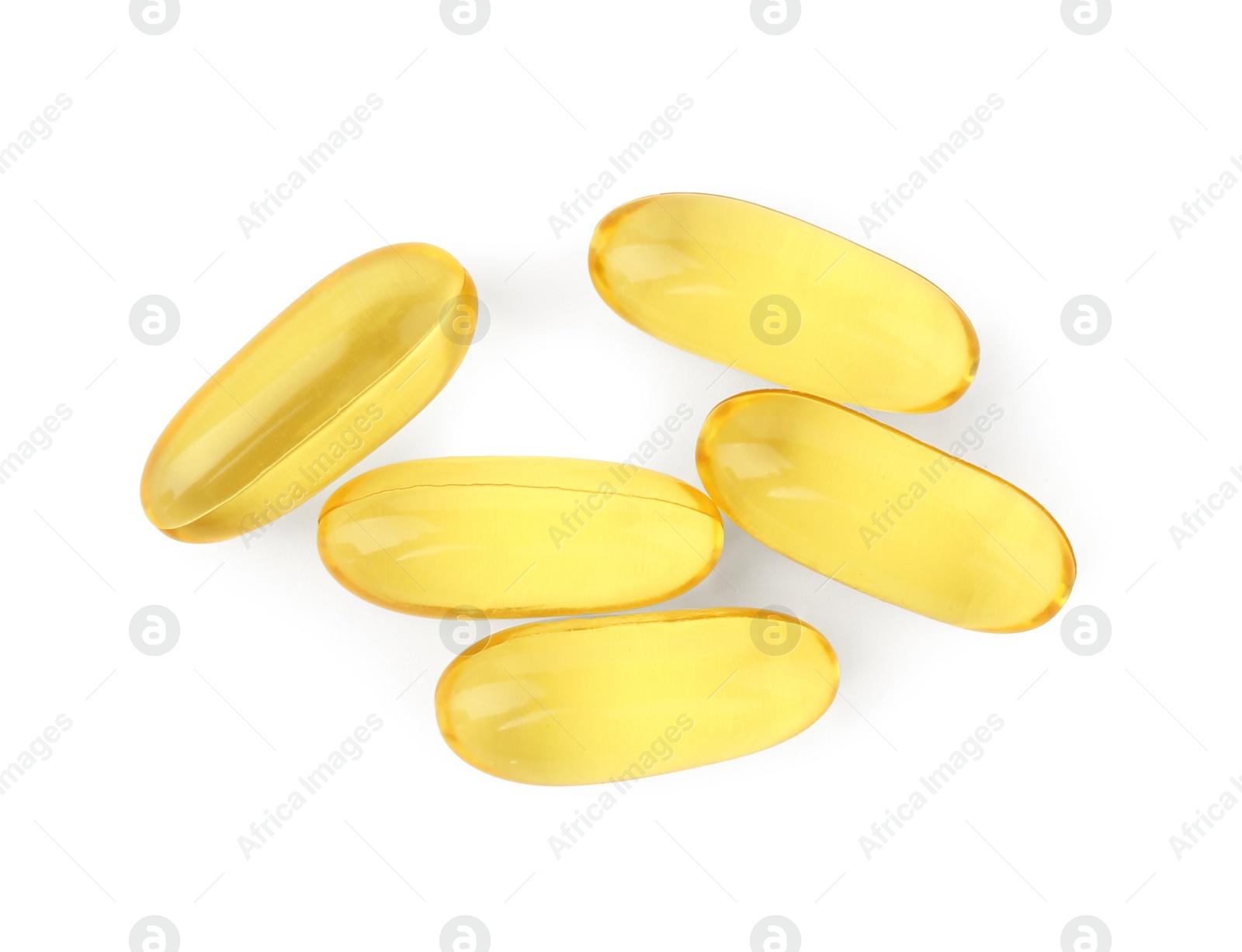 Photo of Many yellow vitamin capsules isolated on white, top view