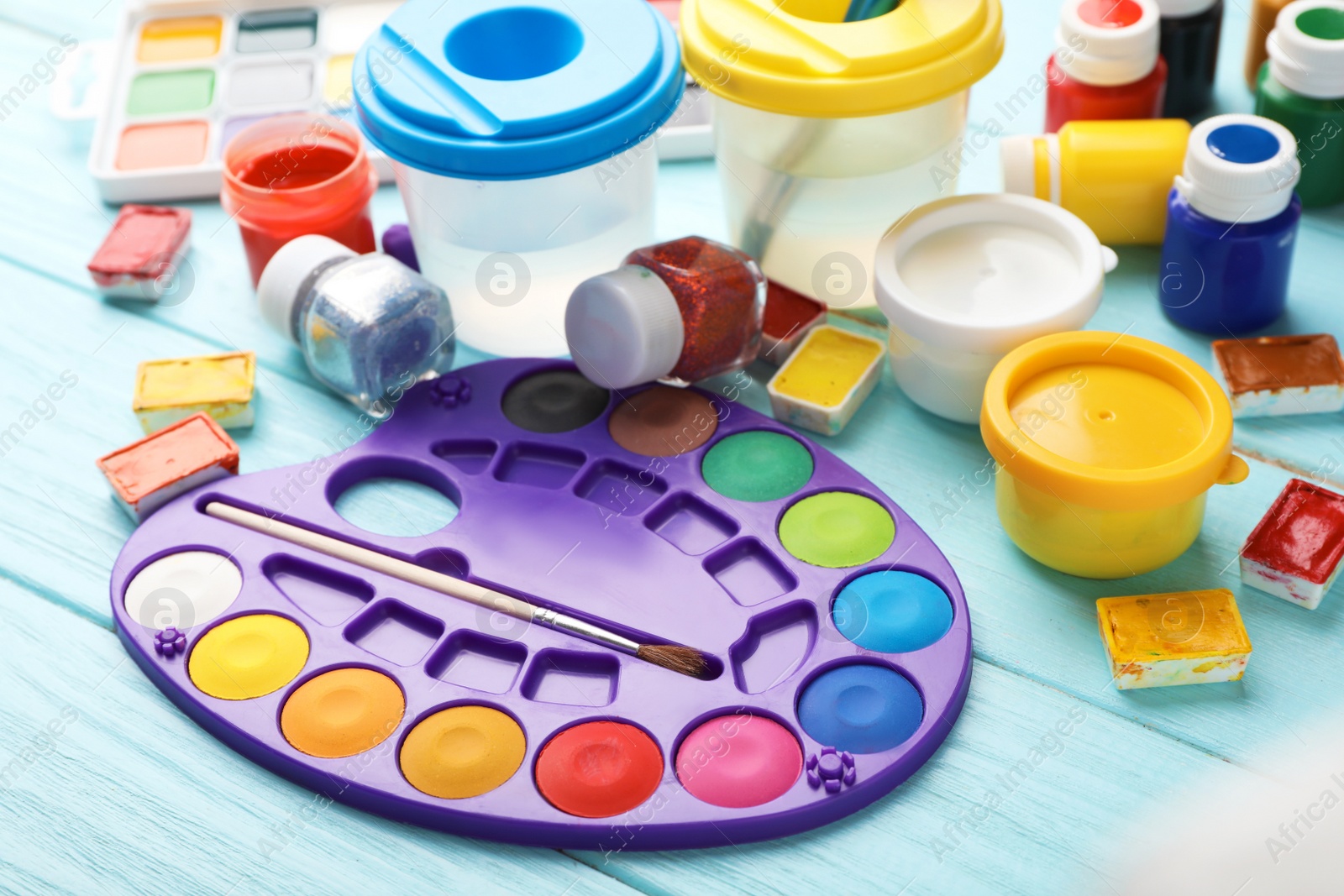 Photo of Set of painting materials for child on color table