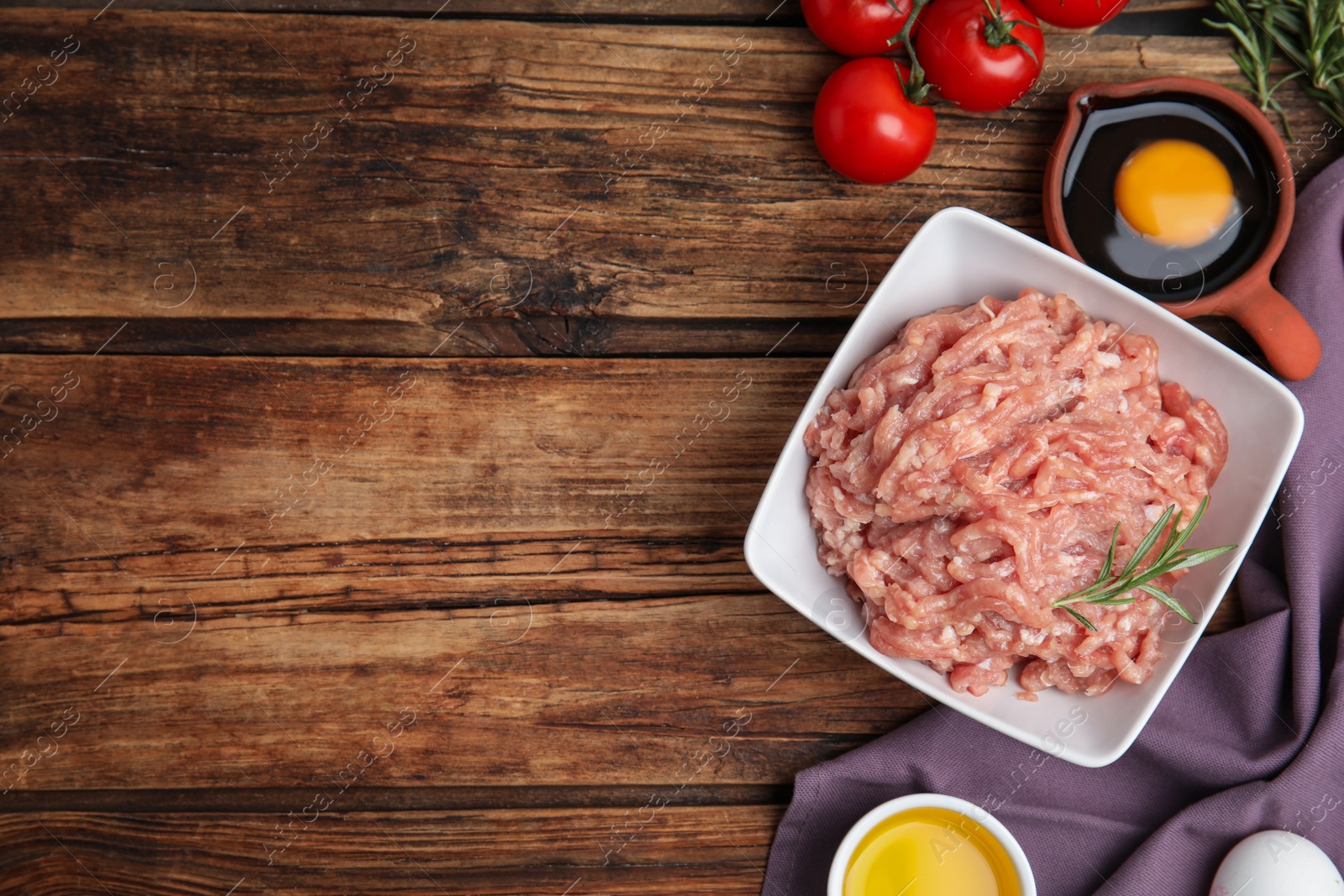 Photo of Raw chicken minced meat and ingredients on wooden table, flat lay. Space for text