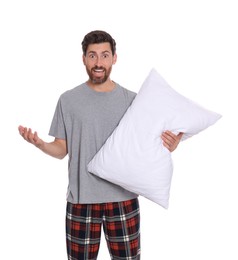 Photo of Excited handsome man with pillow on white background