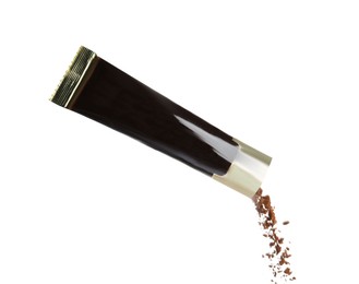 Photo of Pouring aromatic instant coffee from sachet on white background