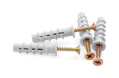 Photo of Plastic dowel screws isolated on white. Hardware tool