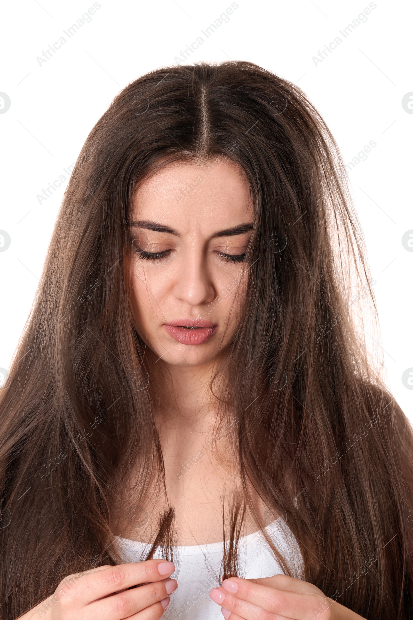 Photo of Emotional woman with damaged hair on white background. Split ends