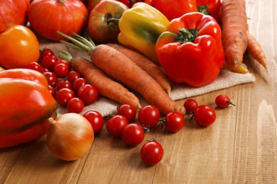 Different fresh ripe vegetables on wooden table