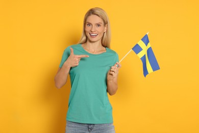 Photo of Woman with flag of Sweden on yellow background