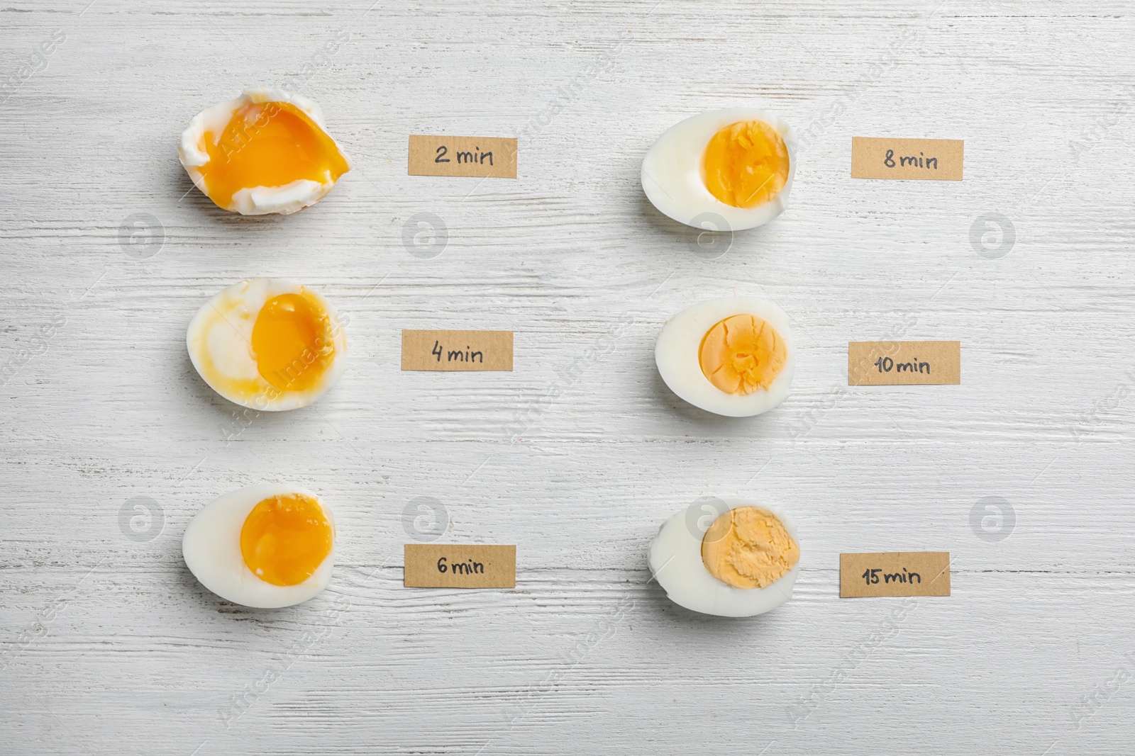 Photo of Various types of boiled eggs on white wooden background, flat lay. Cooking time