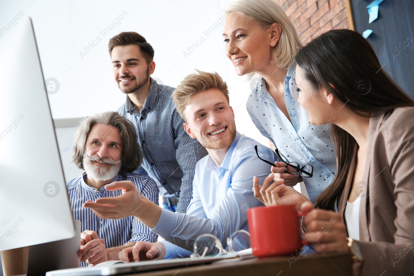 Photo of Business people discussing work matters at table in office. Professional communication