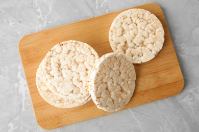 Photo of Crunchy rice cakes on grey marble table, top view