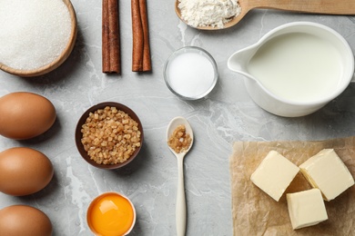 Flat lay composition with fresh ingredients for delicious homemade cake on light grey marble table