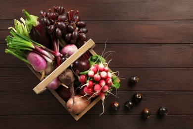 Different fresh ripe vegetables on wooden table, flat lay. Space for text