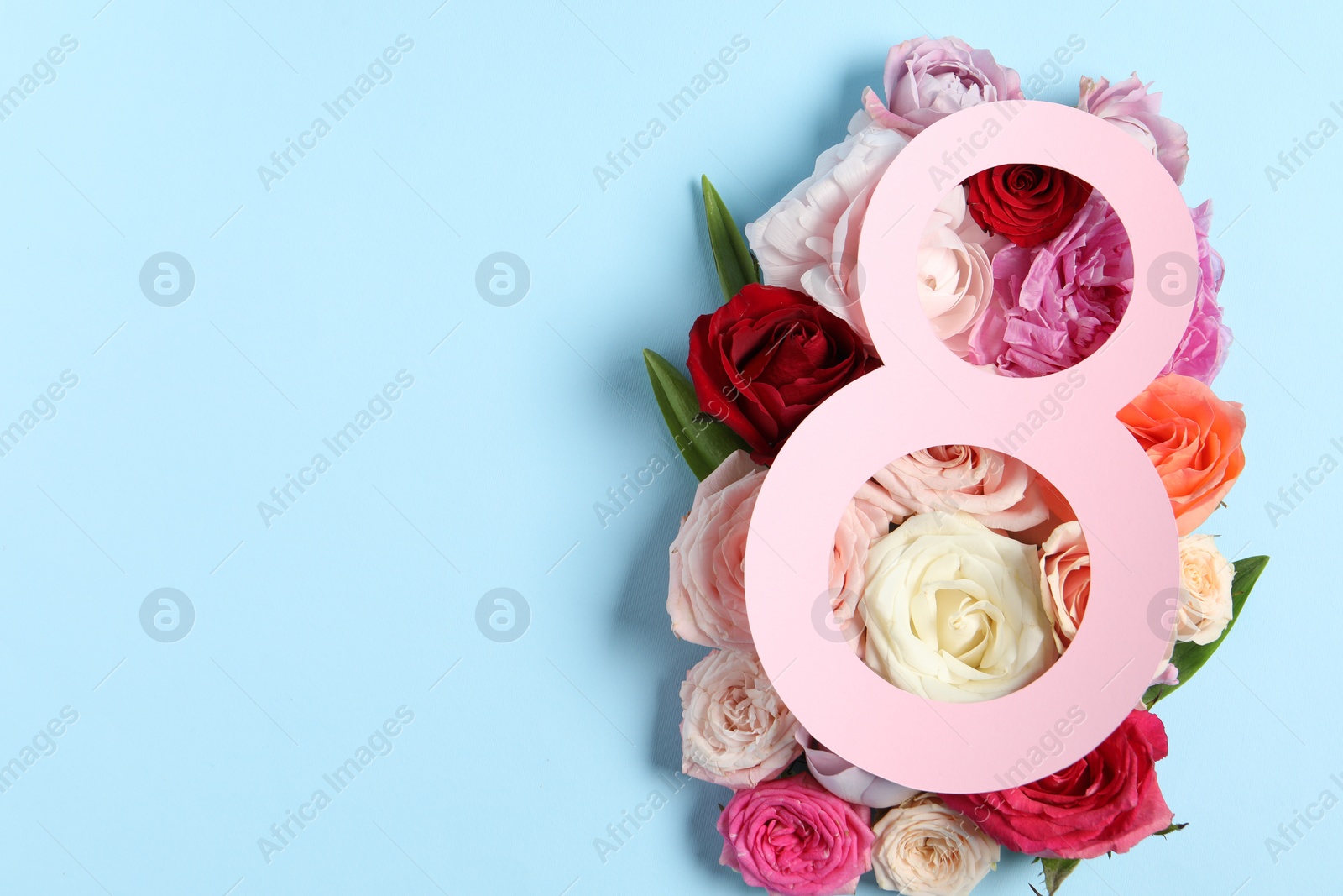 Photo of 8 March greeting card design with beautiful roses on light blue background, top view. Space for text