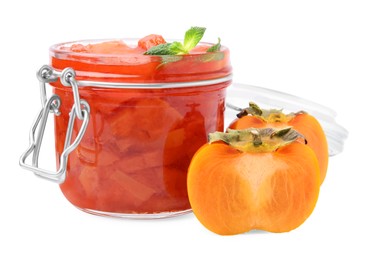 Jar of tasty persimmon jam and fresh fruits on white background