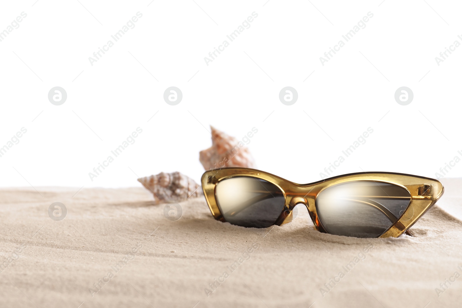 Photo of Stylish sunglasses and shells on sand against white background. Space for text