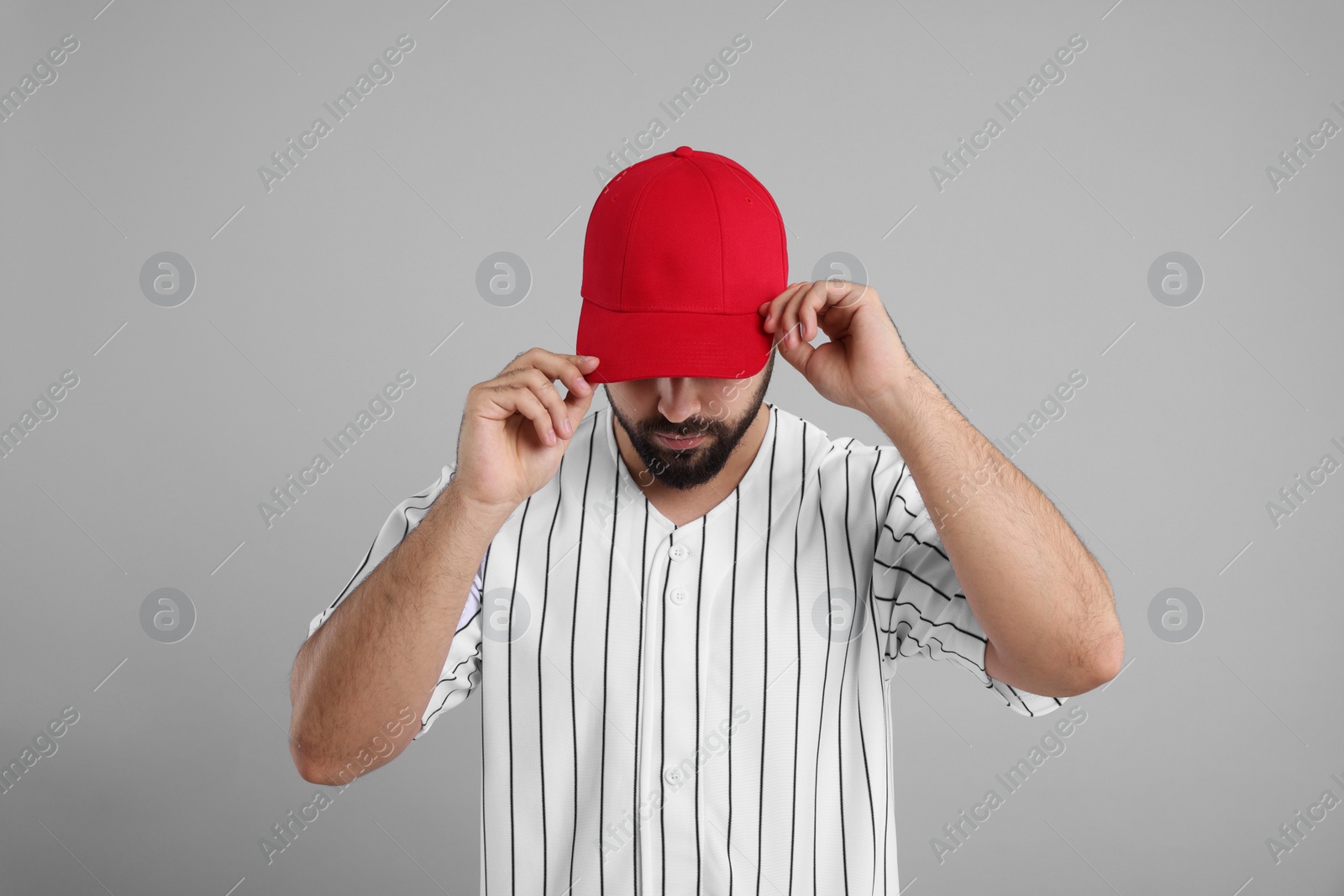 Photo of Man in stylish red baseball cap on light grey background