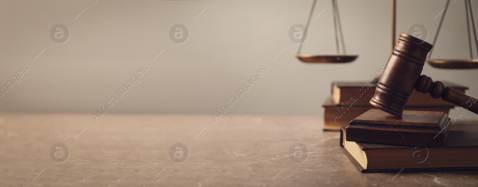 Image of Wooden gavel with scales of justice and books on lawyer's table, space for text. Banner design