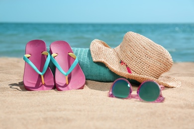 Set of different beach objects on sand near sea