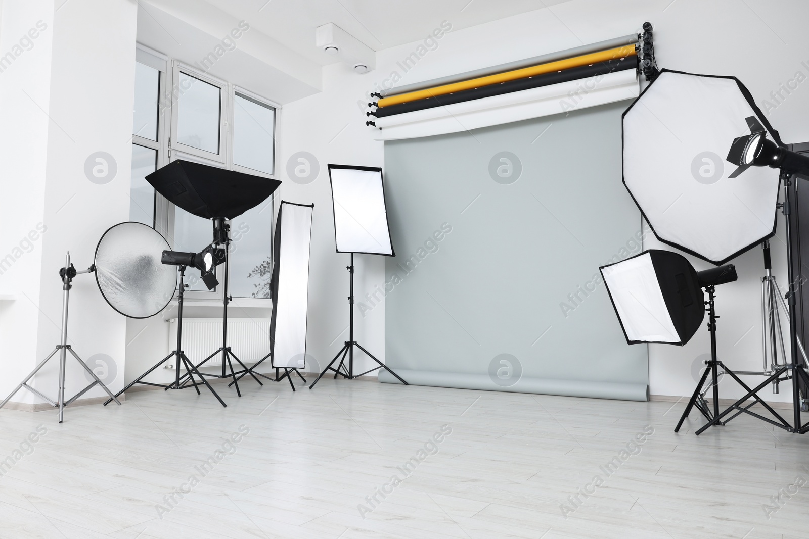 Photo of Interior of modern photo studio with professional lighting equipment