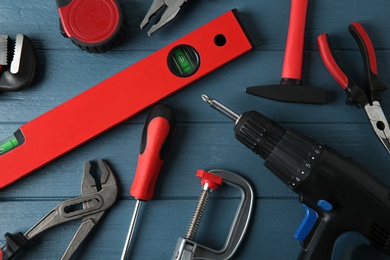 Photo of Set of repair tools on blue wooden background, flat lay