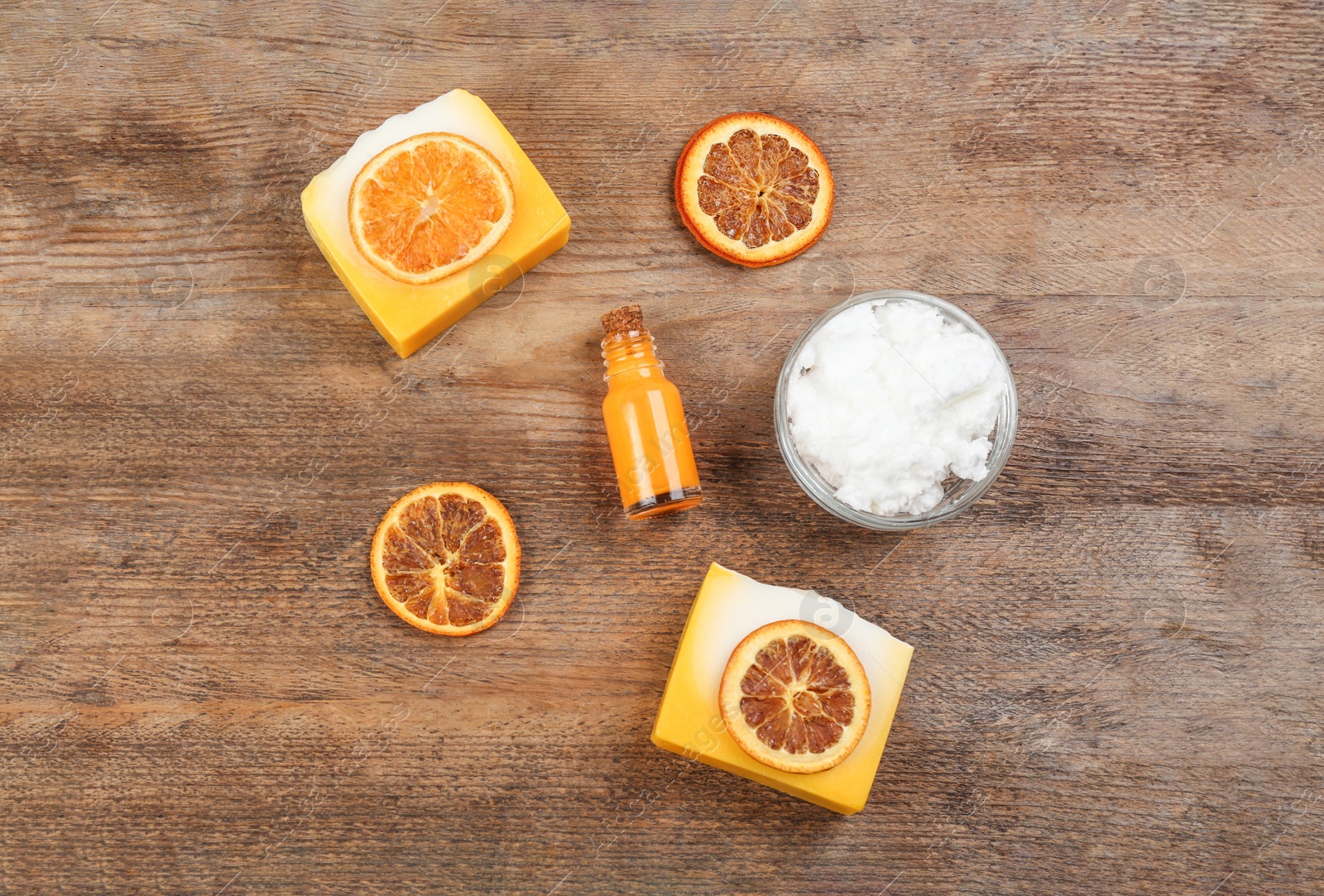 Photo of Flat lay composition with natural handmade soap and ingredients on wooden table