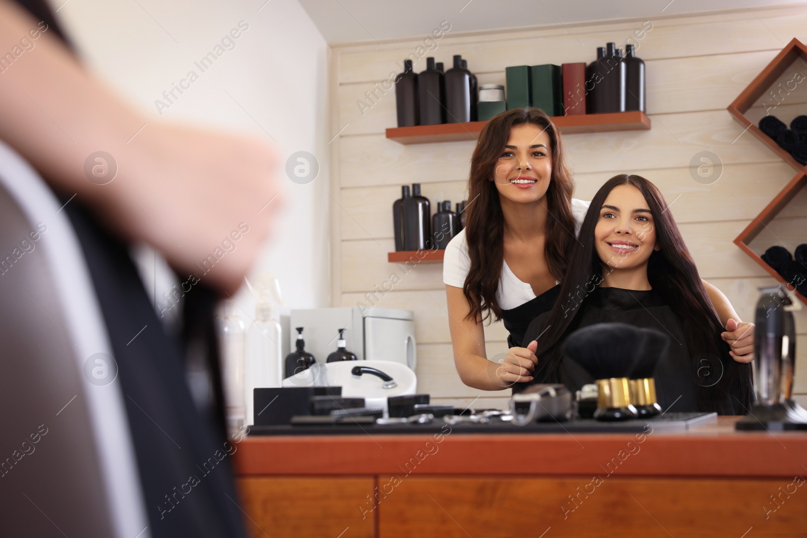 Photo of Hairdresser working with client in beauty salon