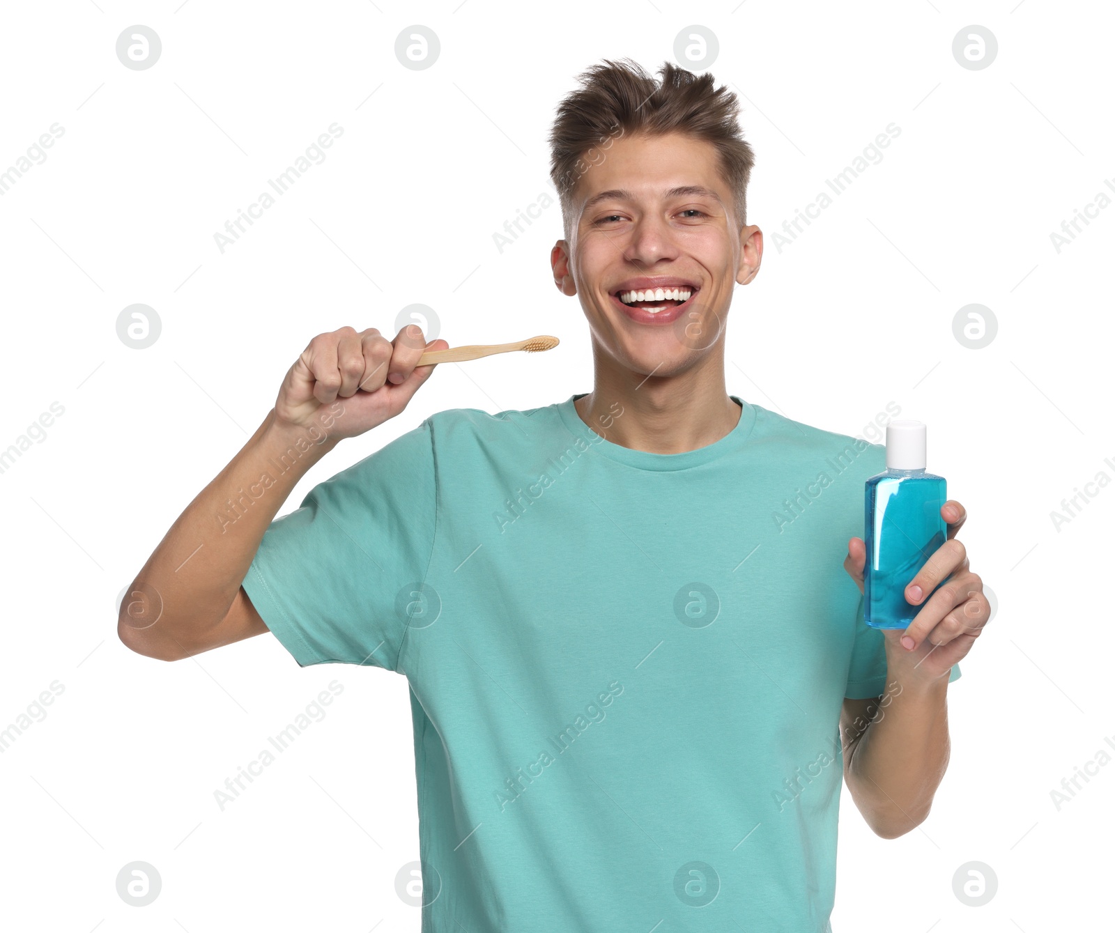 Photo of Young man with mouthwash and toothbrush on white background