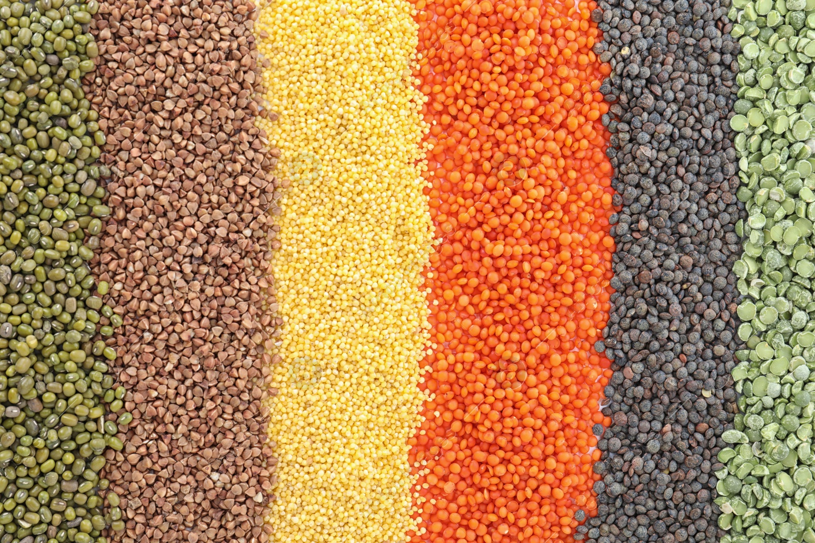 Photo of Different grains and cereals as background, top view