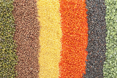 Photo of Different grains and cereals as background, top view