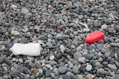 Photo of Plastic bottles thrown out on pebble coast