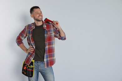 Photo of Handsome worker with wrench on white background, space for text