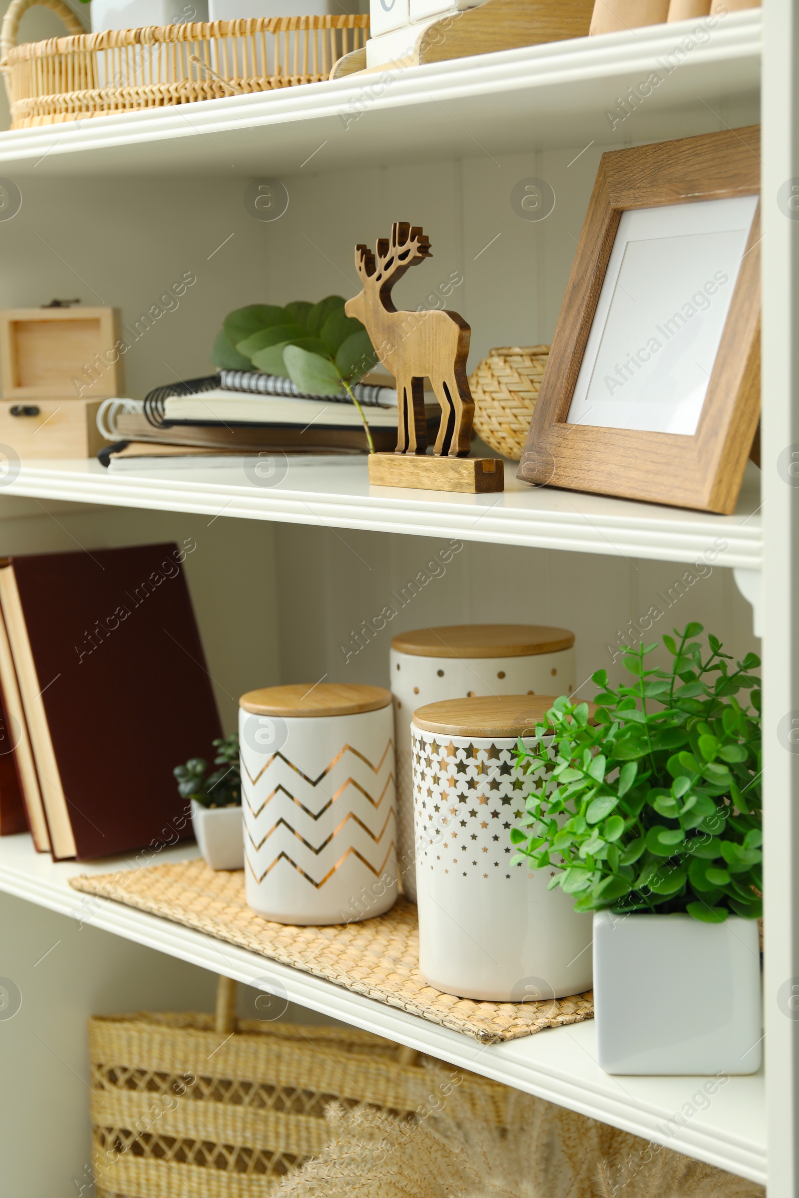 Photo of White shelving unit with different decorative elements