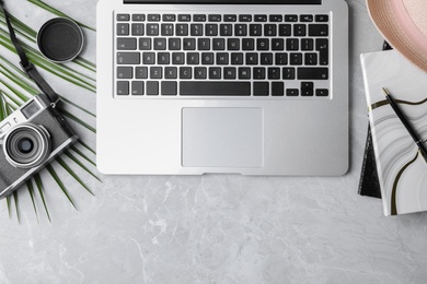 Photo of Flat lay composition with laptop and camera on grey background. Blogger's workplace