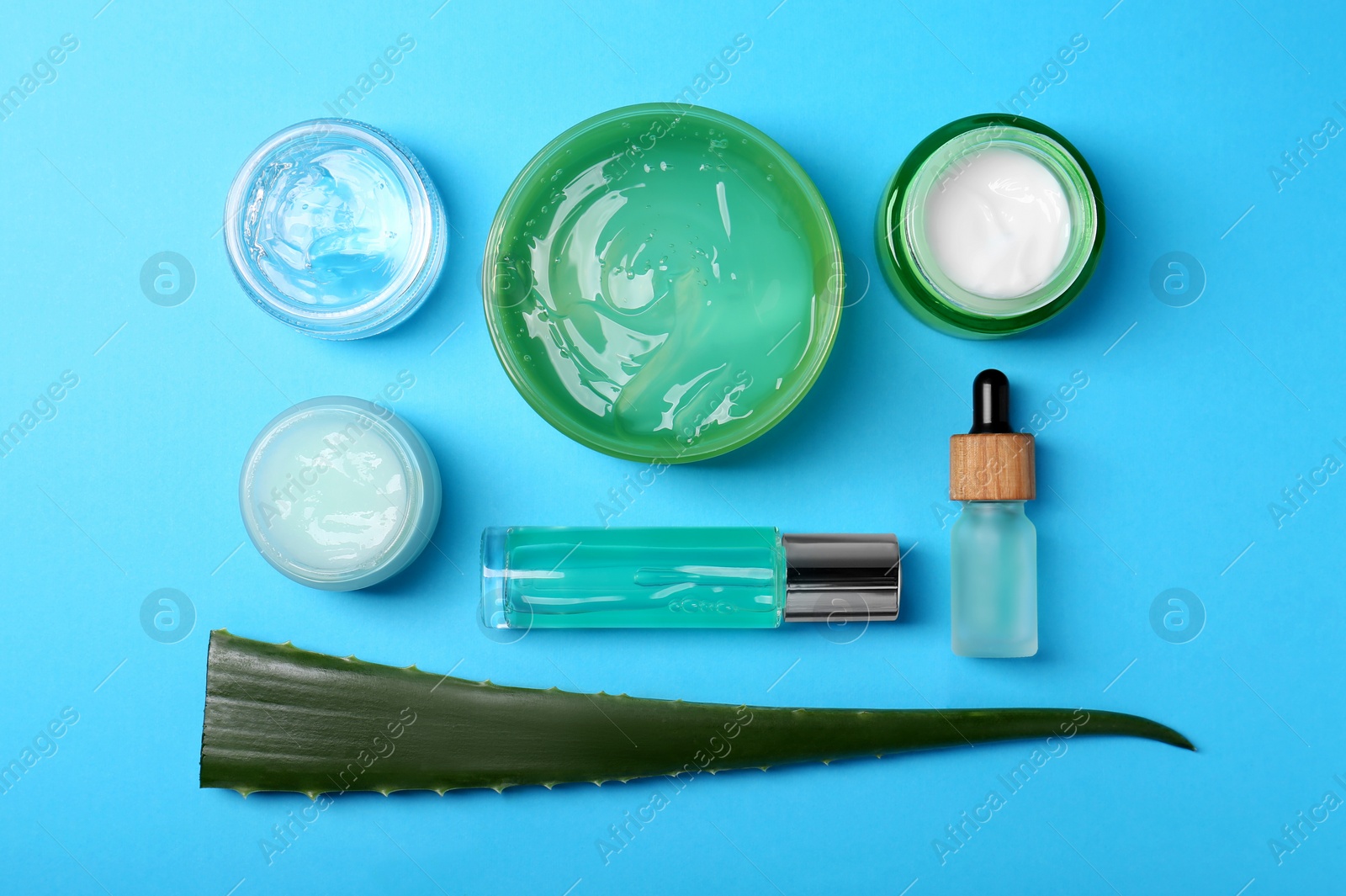Photo of Flat lay composition with aloe and different cosmetic products on light blue background