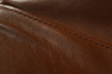 Photo of Brown leather with seam as background, closeup