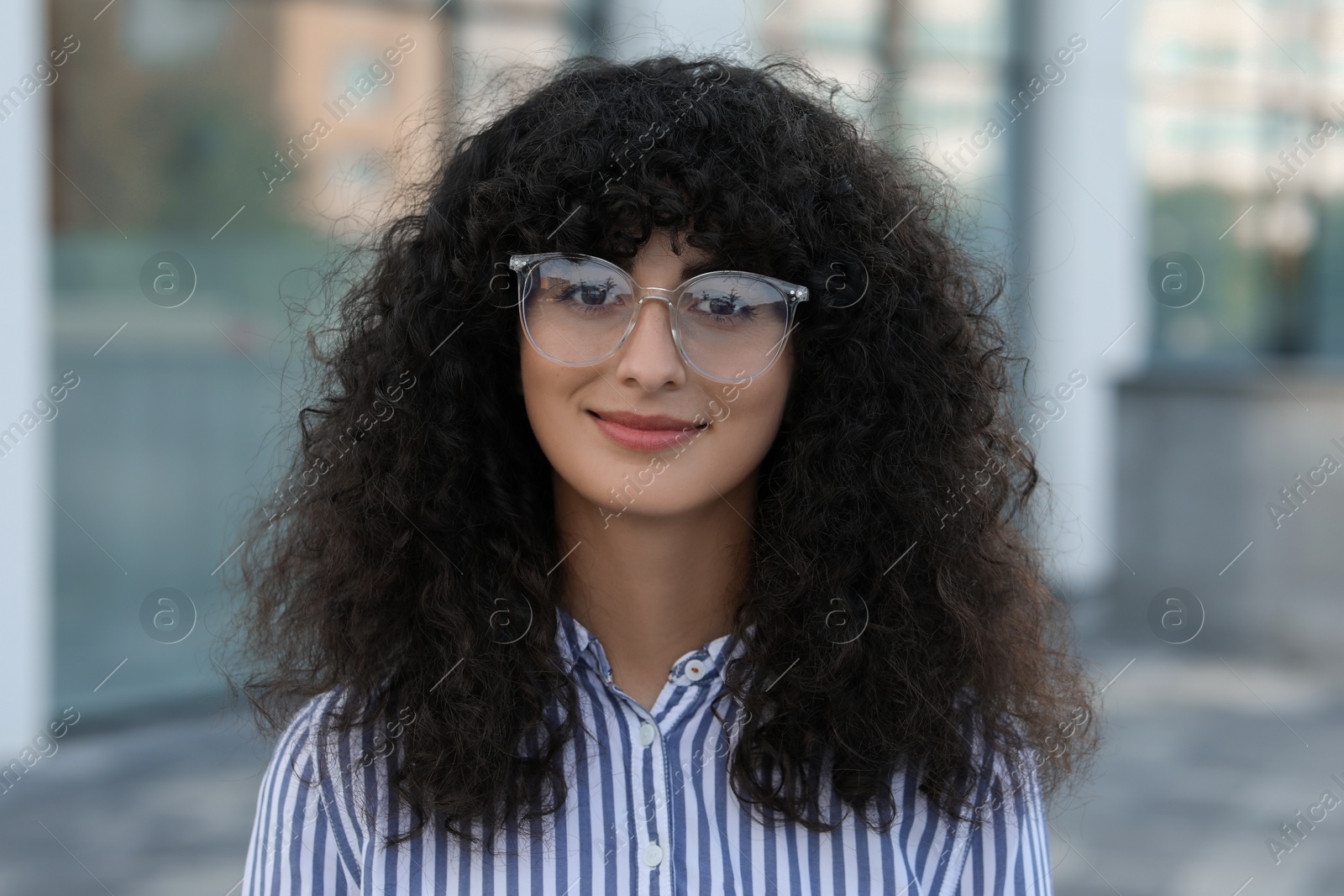 Photo of Portrait of beautiful woman in glasses on blurred background. Attractive lady looking into camera