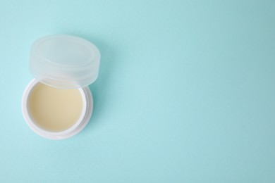 Jar of petroleum jelly on light blue background, top view. Space for text