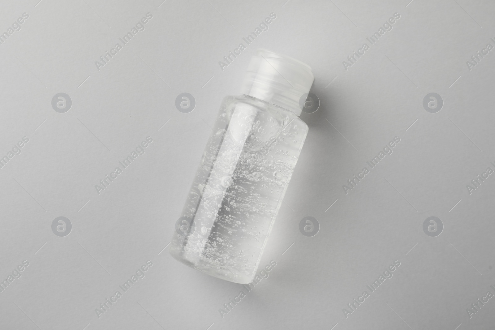 Photo of Bottle of cosmetic gel on white background, top view