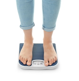 Photo of Woman measuring her weight using scales on white background. Healthy diet