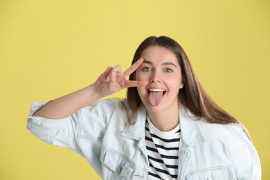 Photo of Portrait of funny young woman on yellow background