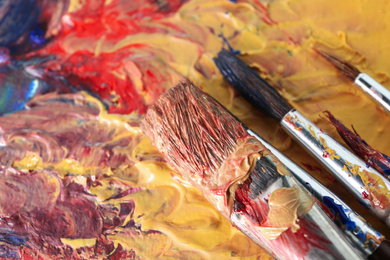 Photo of Abstract colorful artwork and brushes, closeup view