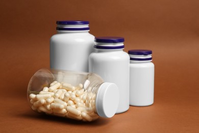 Photo of Many different medicine bottles on brown background