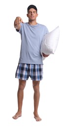 Photo of Somnambulist with blindfold and soft pillow on white background. Sleepwalking