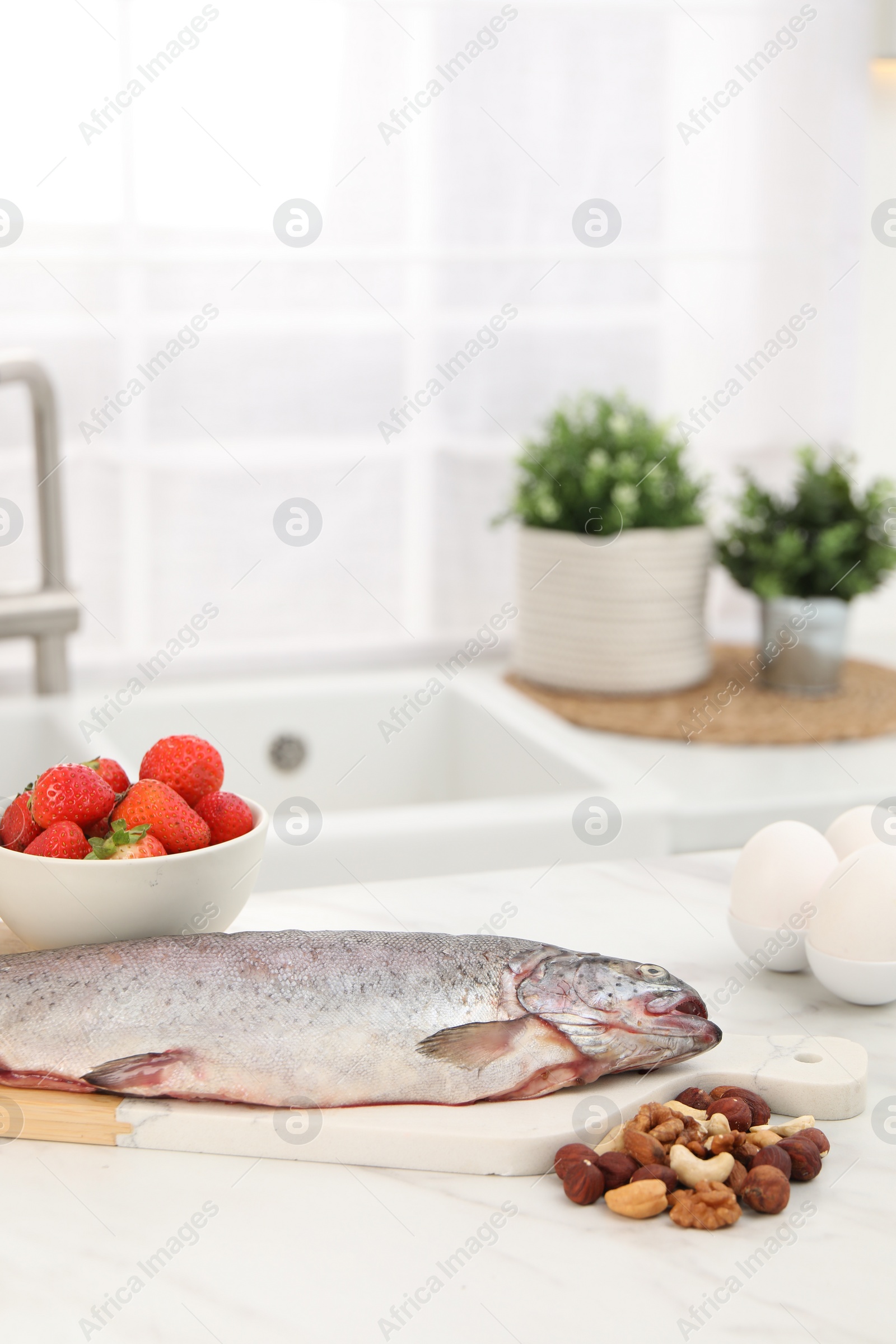 Photo of Allergenic food. Different fresh products on light table in kitchen, space for text