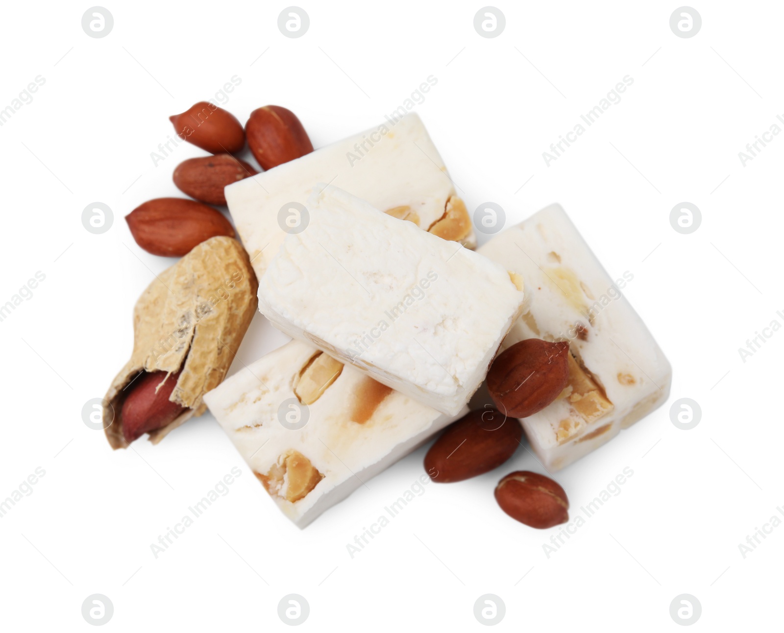 Photo of Pieces of delicious nougat and nuts on white background, top view