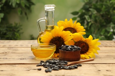 Photo of Composition with sunflower oil on wooden table against blurred background